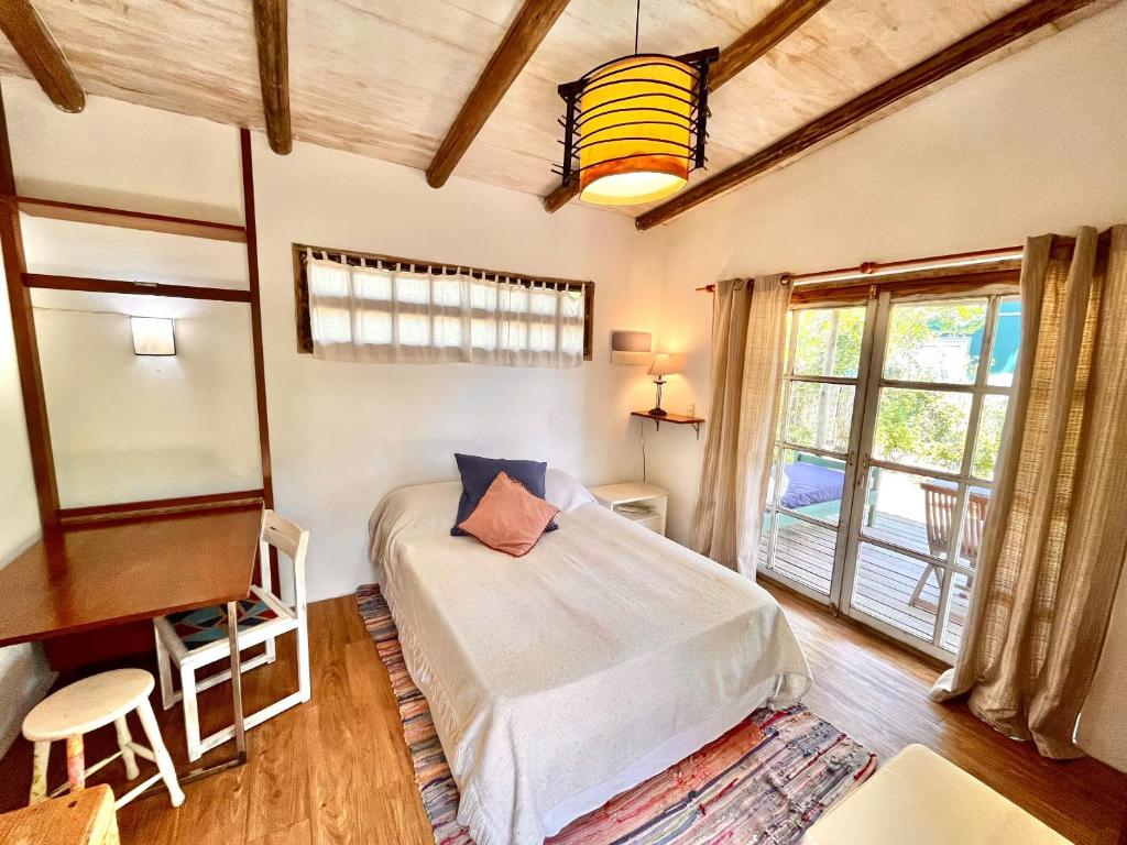 a bedroom with a bed and a desk and a window at Loft en La Juanita in José Ignacio