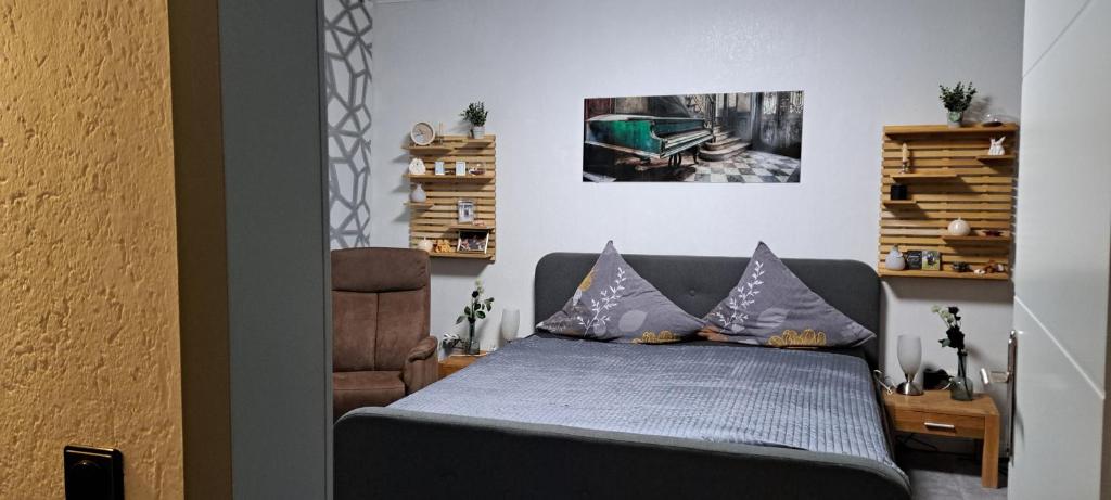 a bedroom with a bed and a chair at Schneeglöckchen in Marl