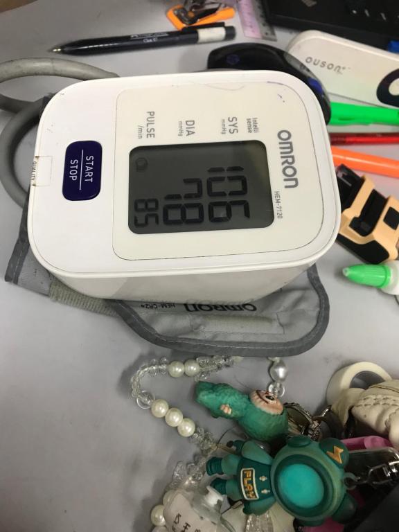 a clock sitting on top of a table with toys at pina in Bintulu