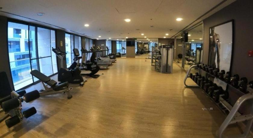 a gym with a row of treadmills and machines at Downtown pearl Amman in Amman
