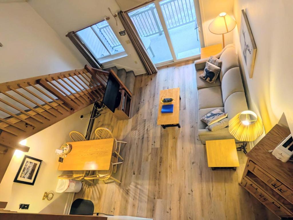 an overhead view of a living room with a couch at Two Bedroom Loft Apartment Sleeps 8 with River Views near Loon Mountain in Lincoln