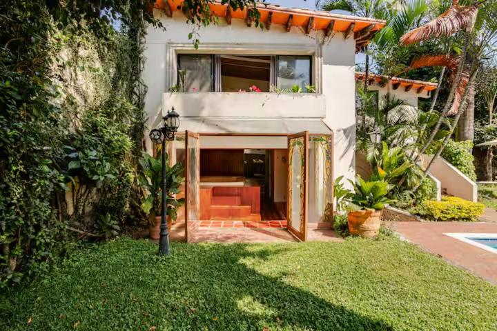 a house with a window and a couch in a yard at Quinta San Francisco in Cuernavaca