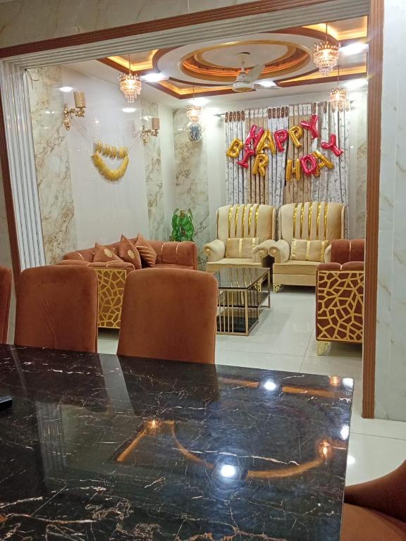 a lobby with couches and a table in a room at Al IMRAN villa 2 bedroom apartment in Lahore