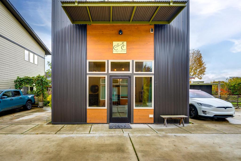 a building with a door and a parked car at 3 Blocks to Dtwn! Cozy Sedro-Woolley Retreat! in Sedro-Woolley