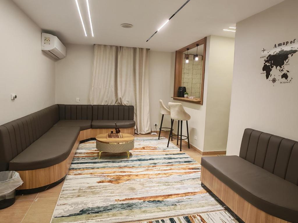 a living room with a couch and a table at Tahrir apartments in Cairo