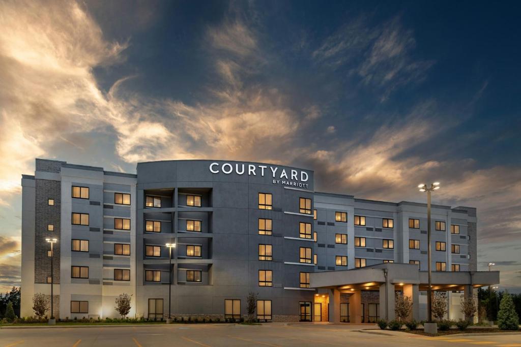 a rendering of a court yard hotel at dusk at Courtyard by Marriott Sherman in Sherman