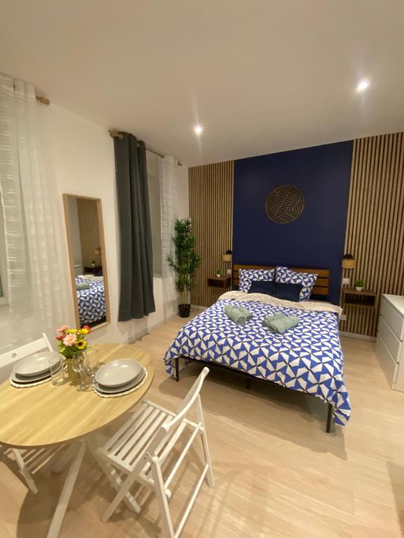 a bedroom with a bed and a table and chairs at Kazkle Etablissement in Boulogne-sur-Mer