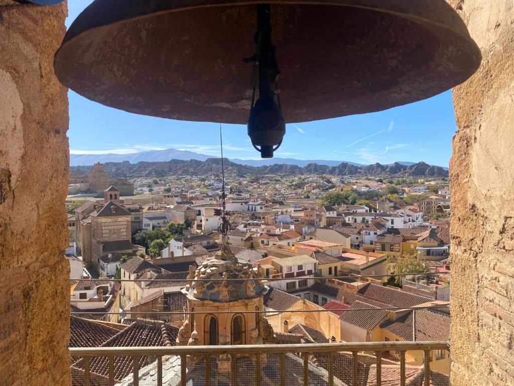 a view of a city from a bell tower at La Ermita in Guadix