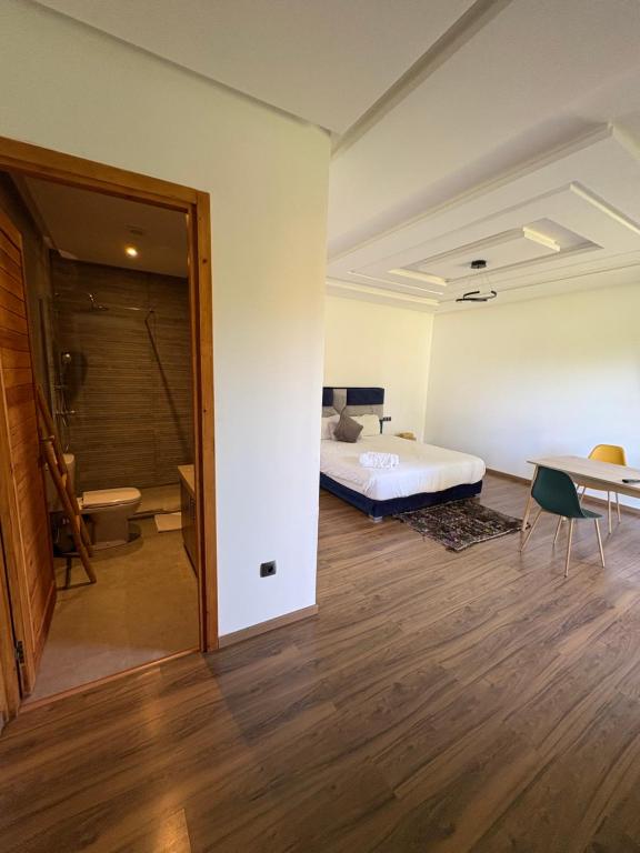 a bedroom with a bed and a desk and a table at Villa Sofia And Spa in Marrakech