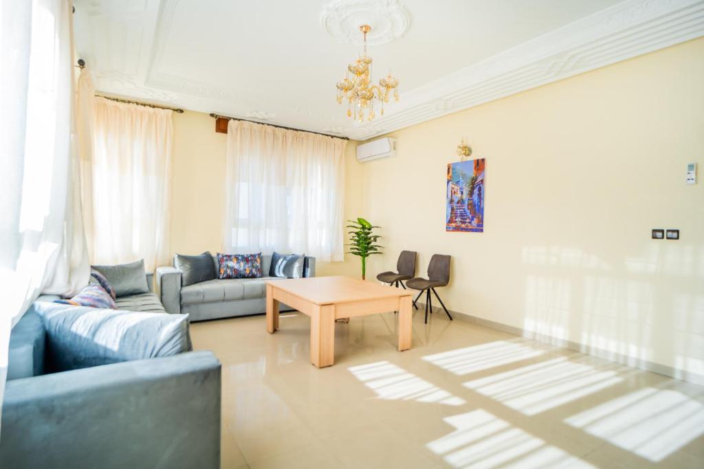 a living room with a couch and a table at RESIDENCE Al SALAM in Tangier