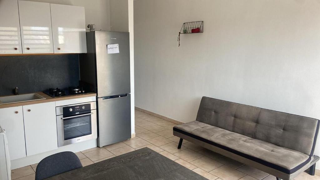 a kitchen with a couch in a kitchen with a refrigerator at Apartment in Cupecoy