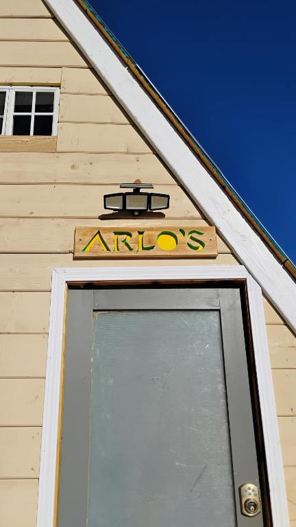 a building with a sign above a door at Arlo's AFrame in Joshua Tree