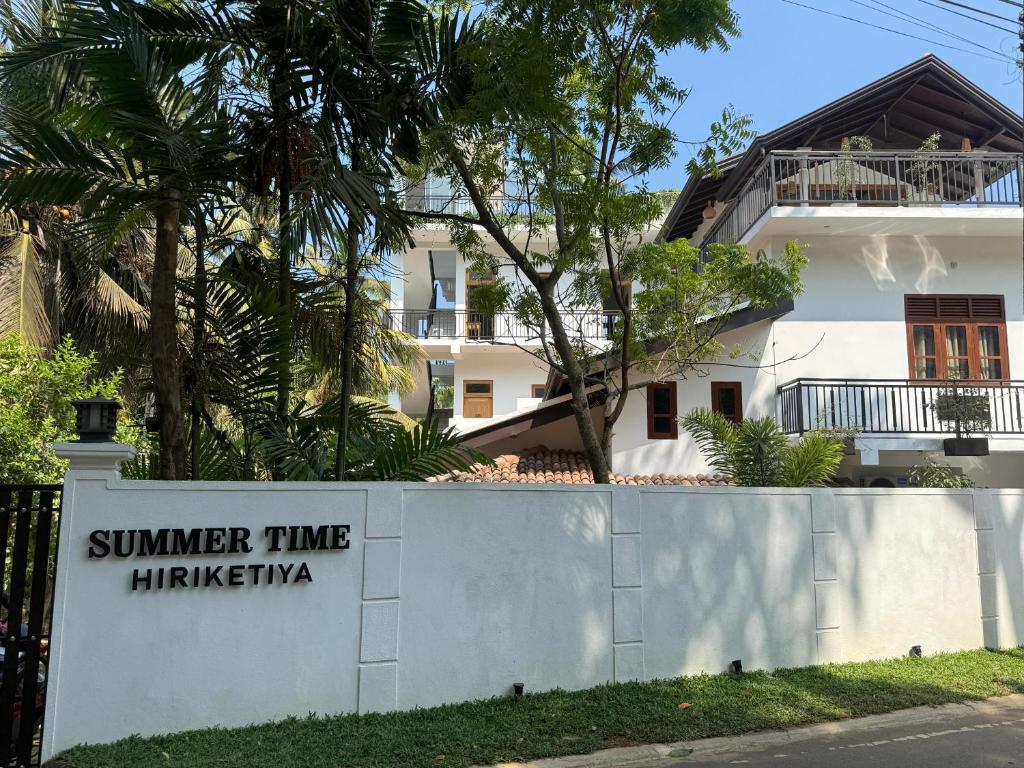 a sign for the summer time hickingham in front of a house at Summer Time Hiriketiya in Dickwella