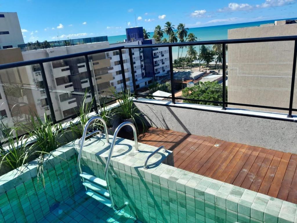 a swimming pool on the balcony of a building at Aurea 310 in Tambaú