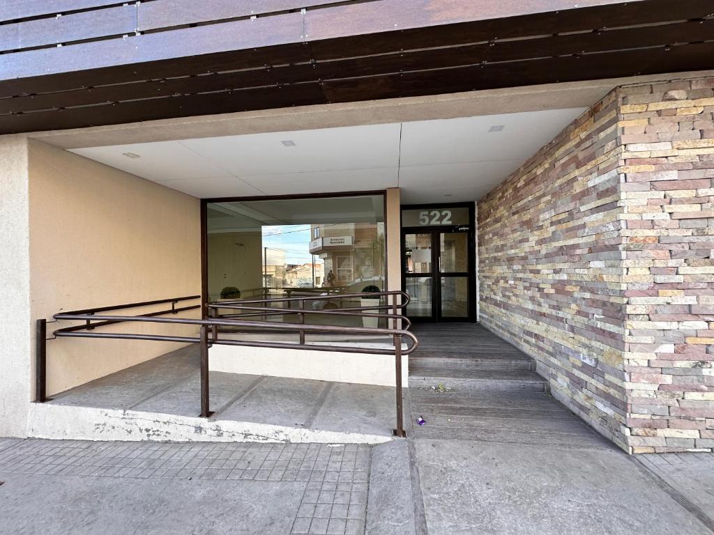 an entrance to a building with a glass window at Belgrano Apart in Comodoro Rivadavia