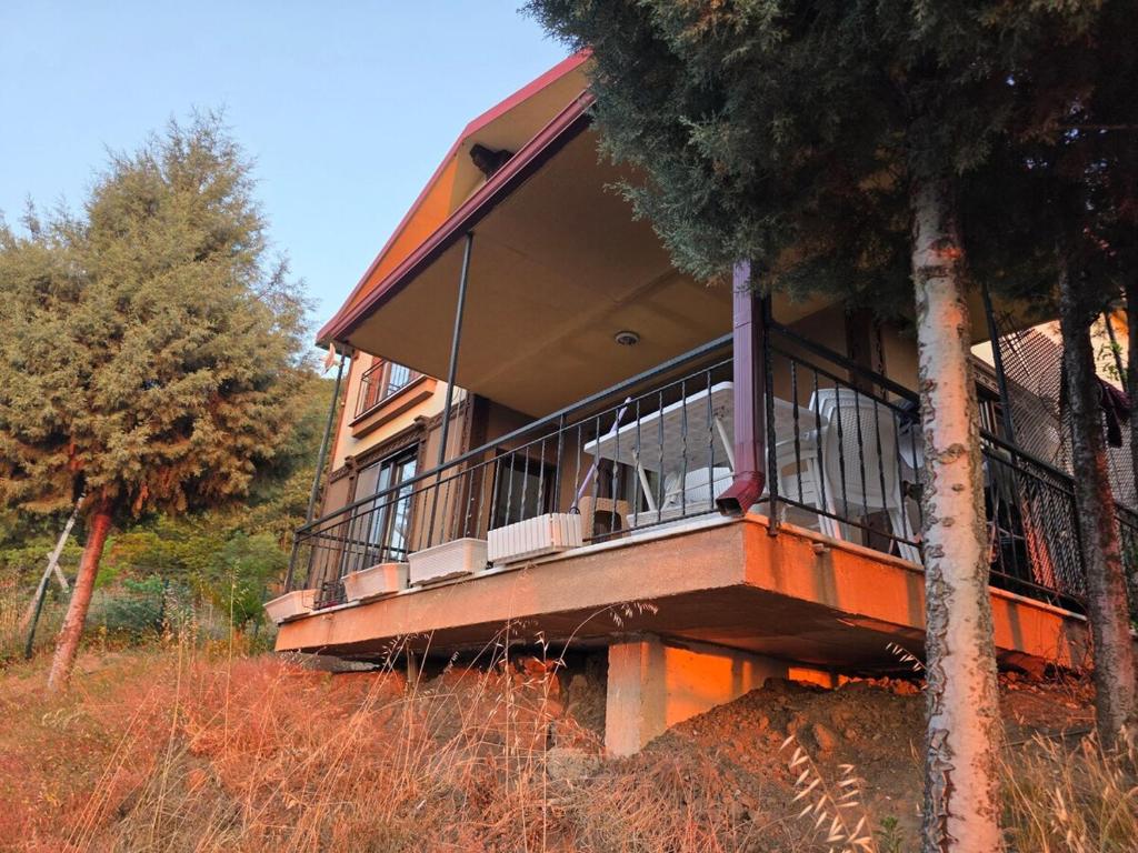 a house with a balcony on the side of it at House overlooking a lake 