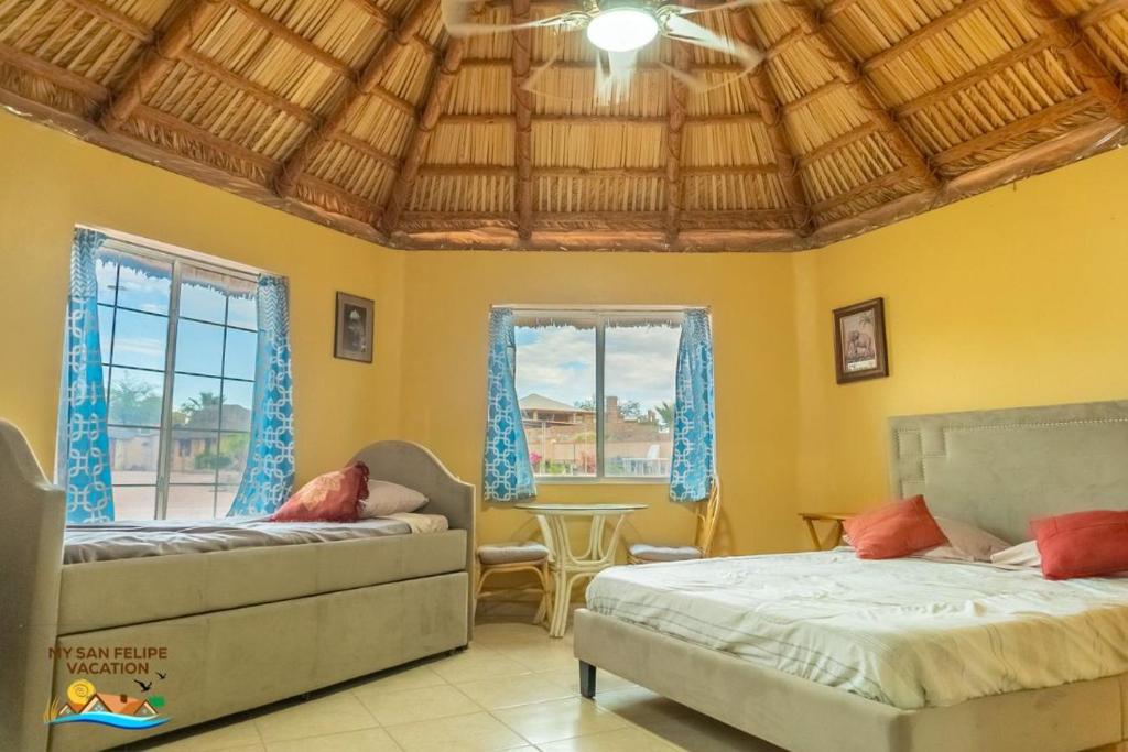 a bedroom with two beds and a table at 1-Bedroom Beach Studio - Serene getaways. in San Felipe