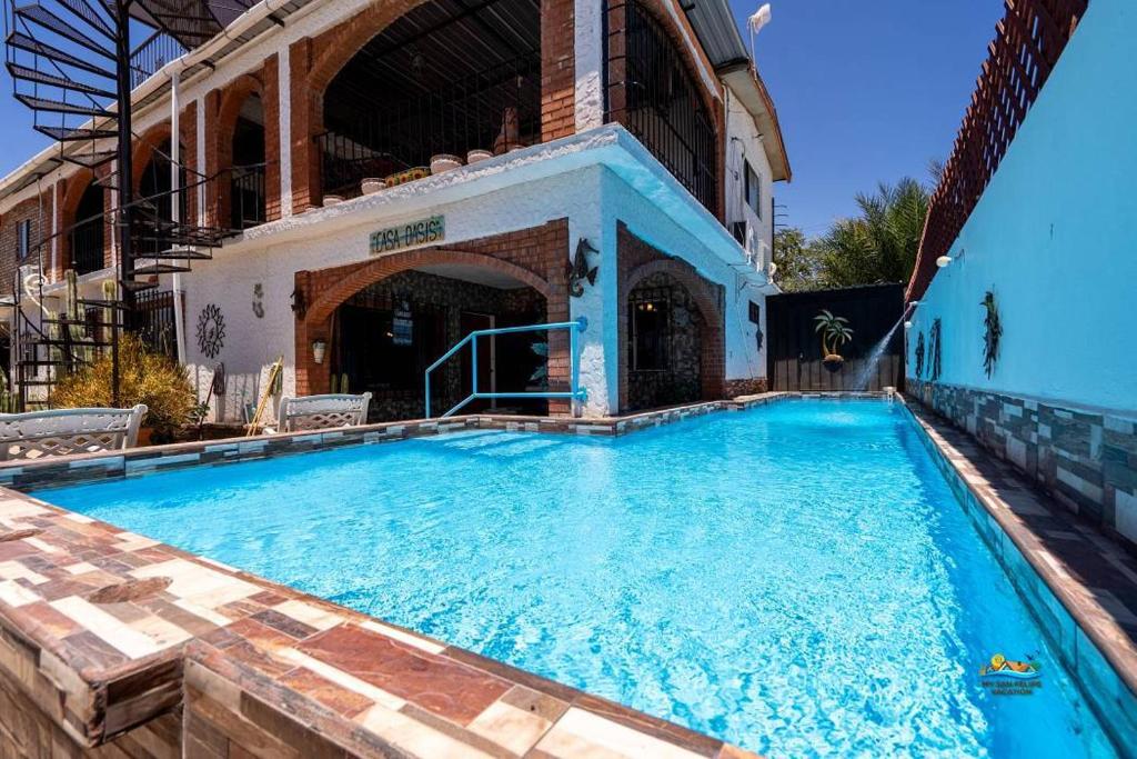 a large swimming pool in front of a building at Huge Family 5 bedroom sleeps 16 with private pool home in San Felipe