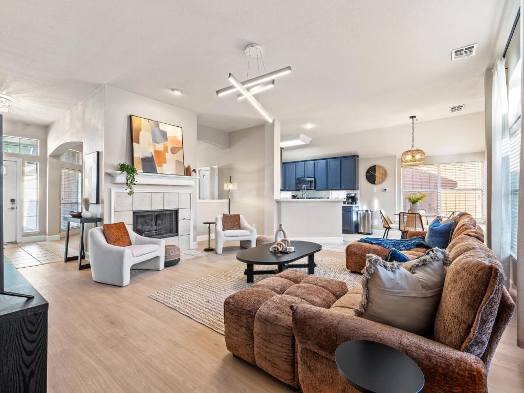 a living room with a couch and a table at Boho Dreamscape 4BD Game Room Pool in The Colony