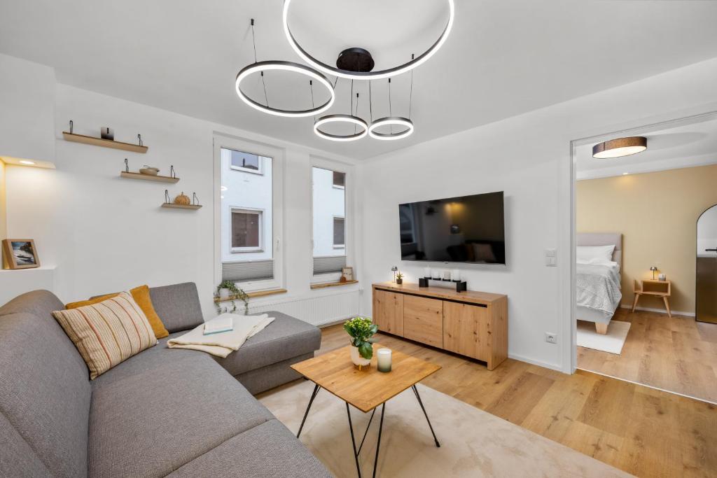 a living room with a couch and a table at Exklusive City Apartments in Bad Kissingen