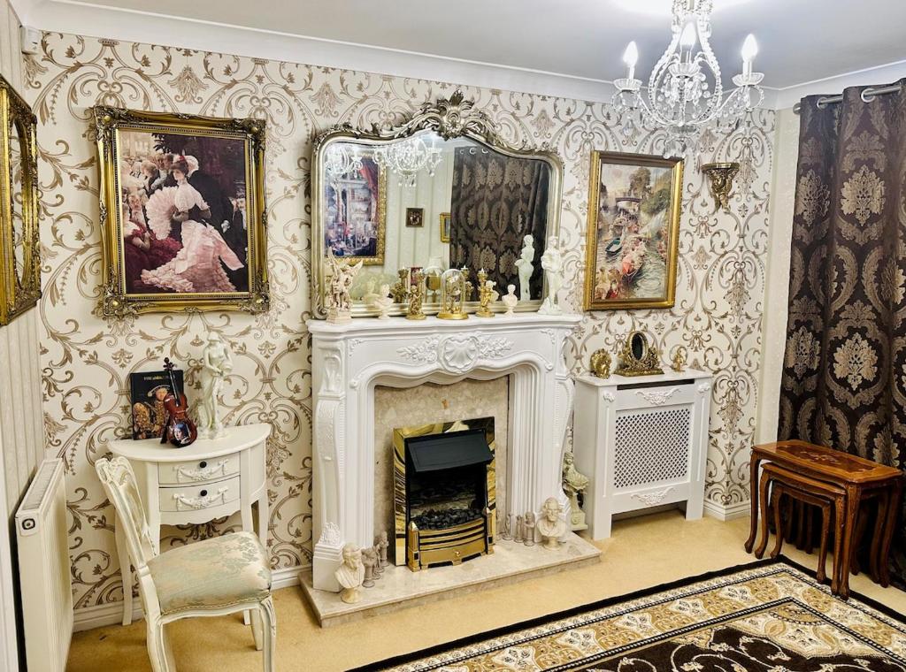 a living room with a fireplace and a mirror at Themed Cosy Home by Cannock Chase Forest in Rugeley