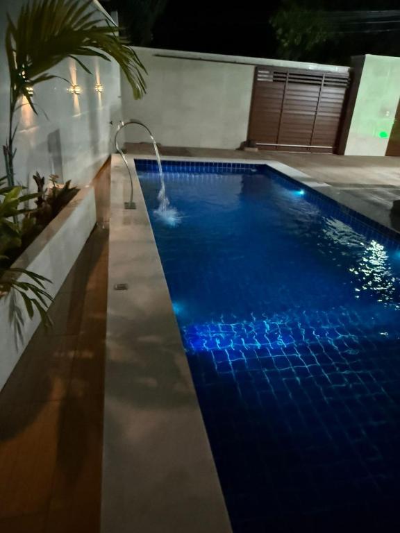 a swimming pool with blue lights in a house at Pousada Essencia de Pipa in Pipa