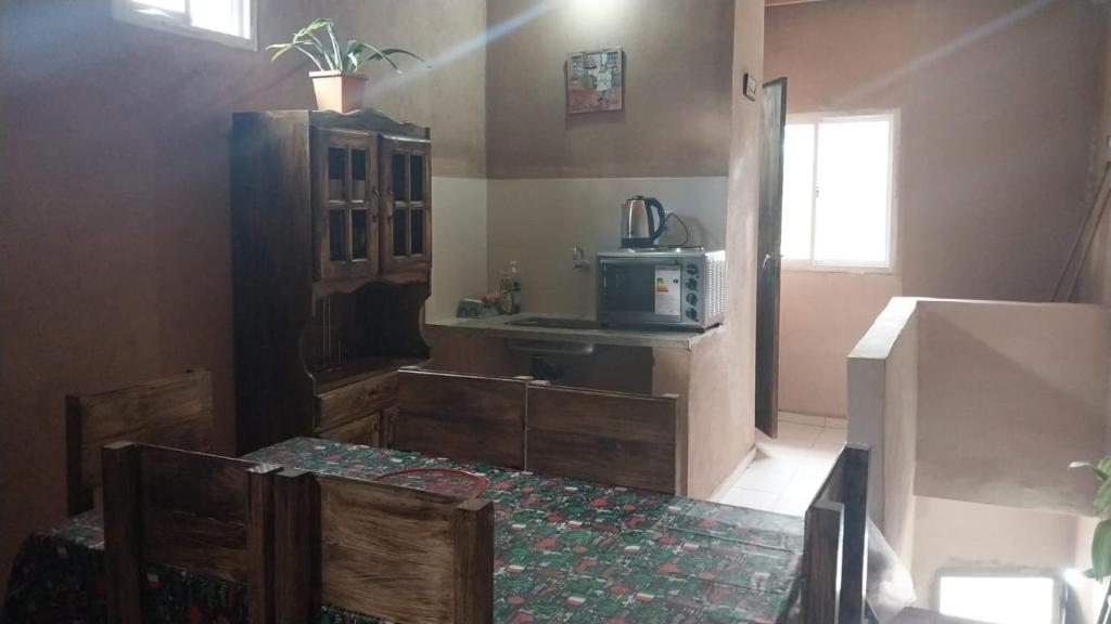 a kitchen with a table and a microwave at El Shaddai I in Santiago del Estero