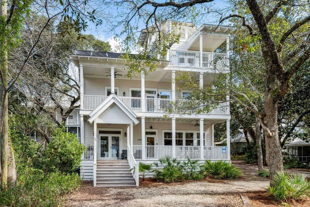 a large white house with white railings and trees at Walk to Seaside and Beach in Santa Rosa Beach