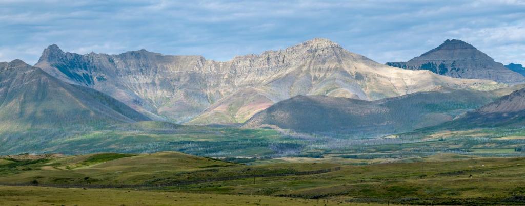 Blick auf eine Bergkette mit grünen Hügeln in der Unterkunft Echos and Embers Waterton in Waterton Park