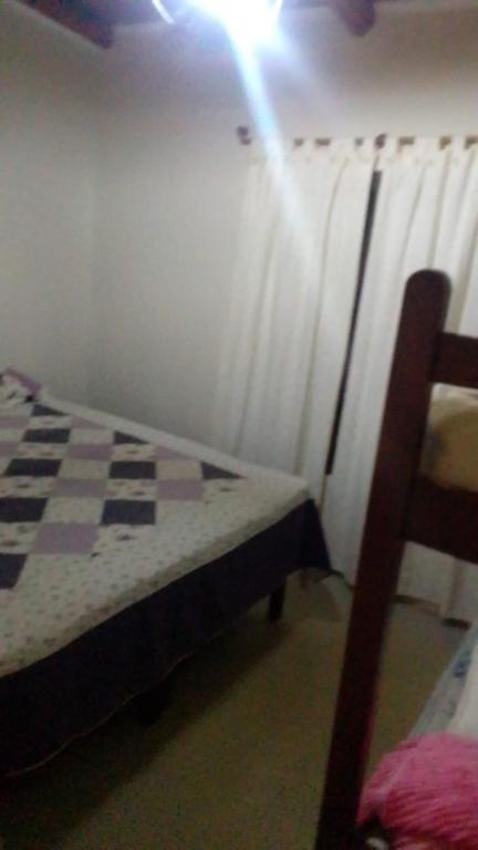 a bedroom with a bed and a window with curtains at Nebel Apart in Concordia