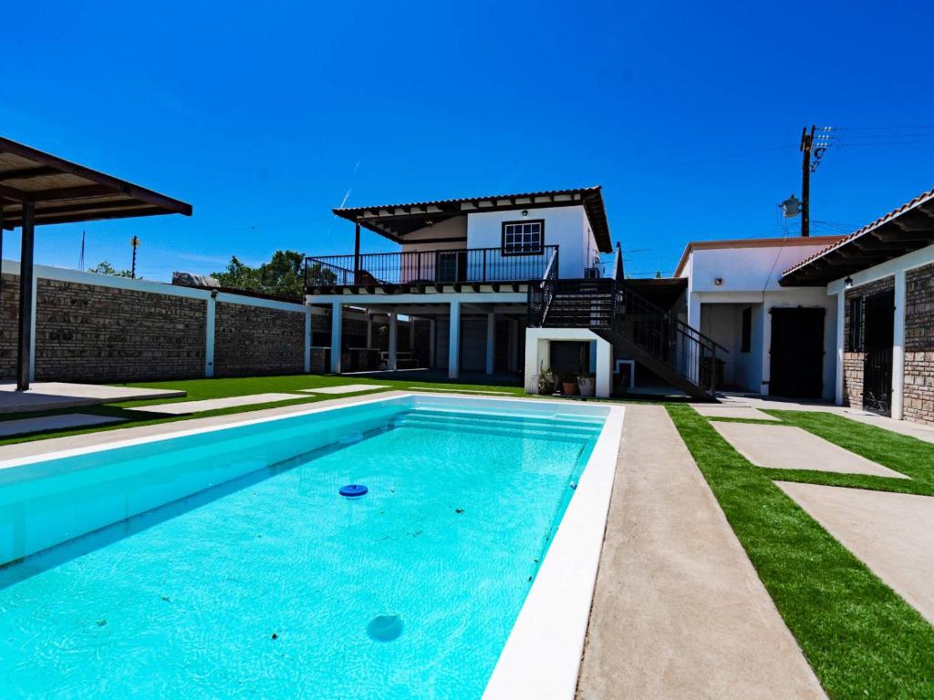 a swimming pool in the backyard of a house at Casa Barquito - Pool house in San Felipe in San Felipe