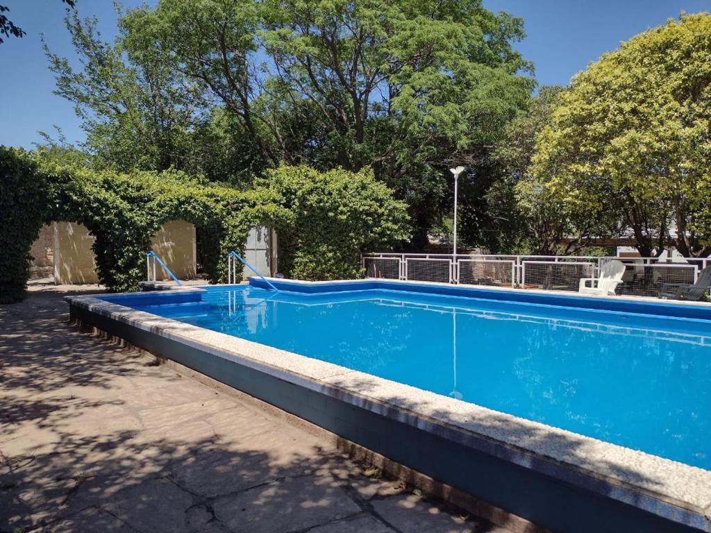 een groot blauw zwembad in een tuin bij Hotel Nuevo Molino in Huerta Grande