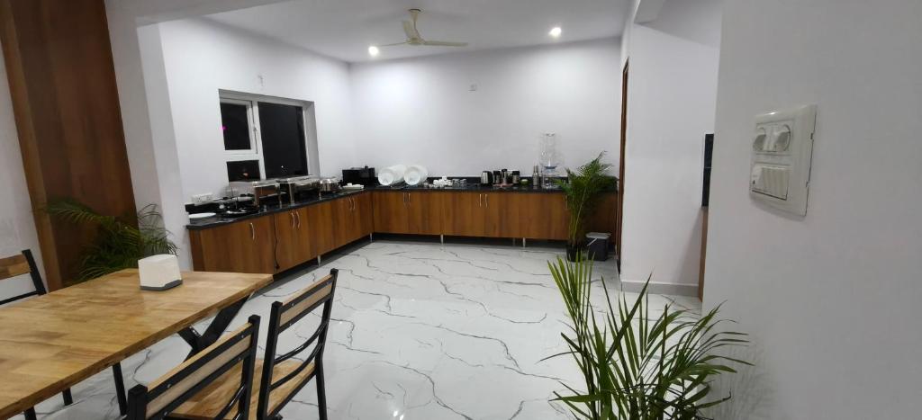 バンガロールにあるKeerthis Comforts -Near Kempegowda international Airport Hotelのテーブルと椅子とカウンターのある部屋