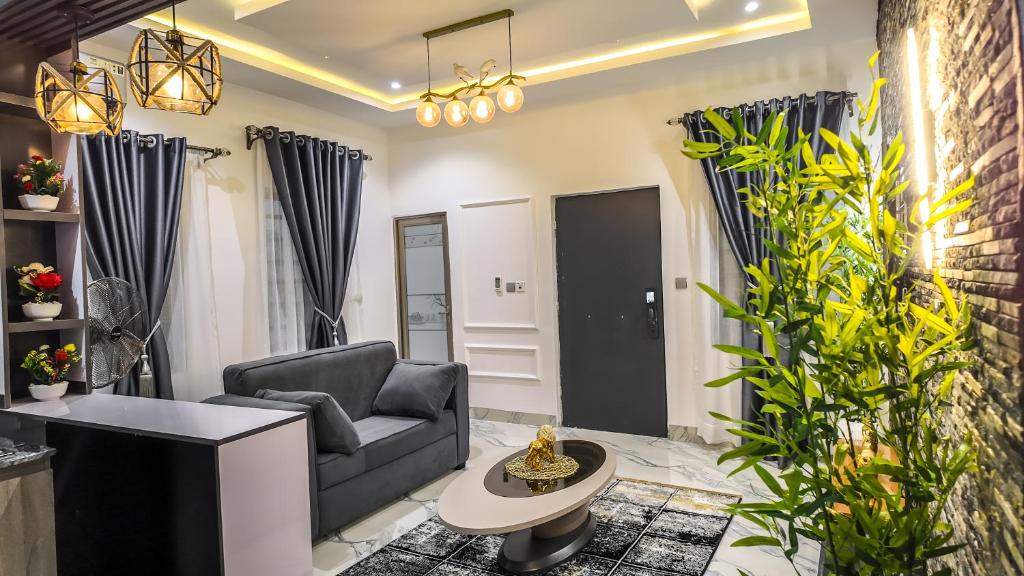a living room with a couch and a table at Jayhaven Crystal Serviced Apartment in Uyo