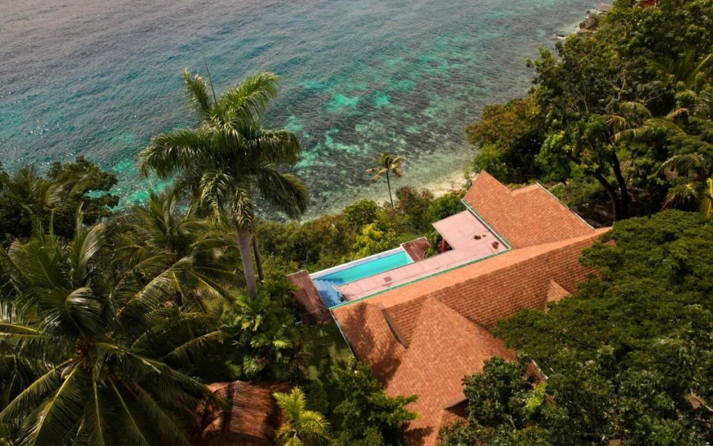 an aerial view of a house next to the ocean at Casa Acantilado Oslob - 3BR in Oslob