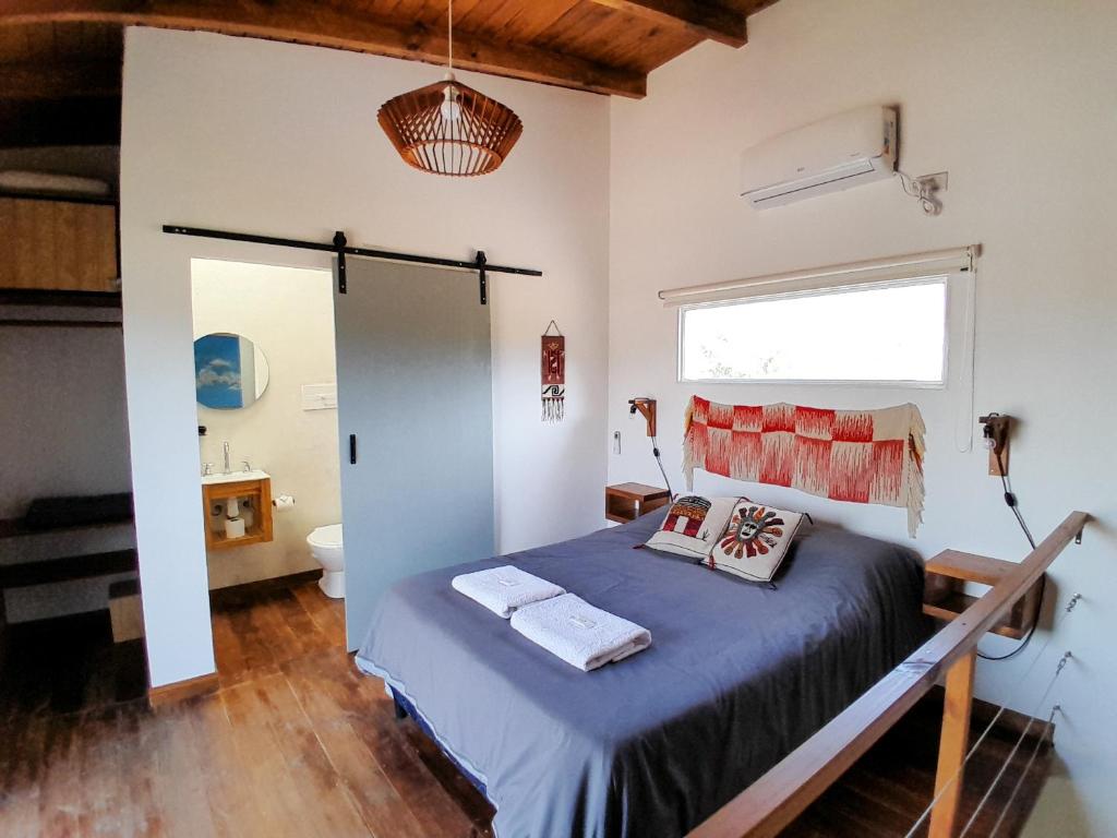 a bedroom with a bed with two pillows on it at Malvón in Cafayate