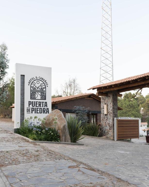 a building with a sign for aeria be tattoo at Hotel Puerta de Piedra in Tapalpa