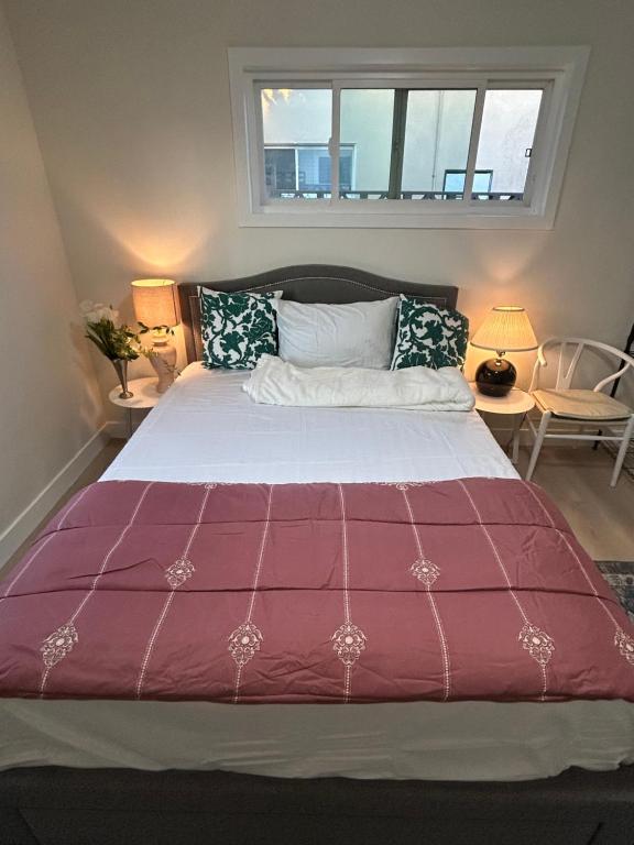 a bedroom with a large bed with a purple comforter at Flora in Ontario