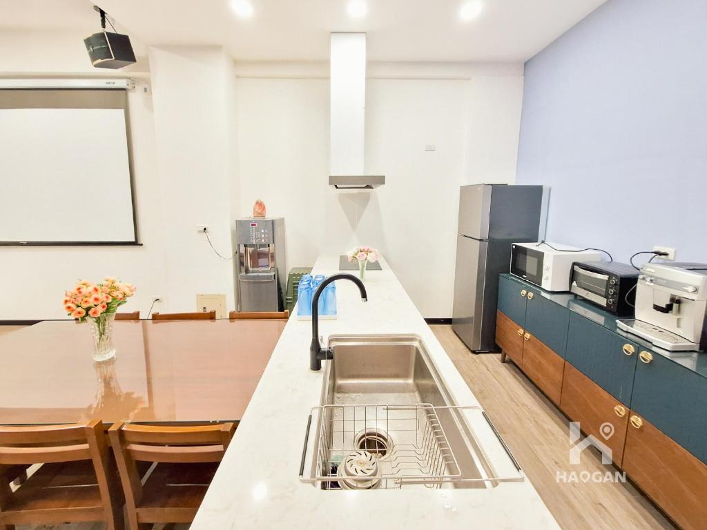 a kitchen with a sink and a counter at 芳心蘭厝民宿 in Wujie
