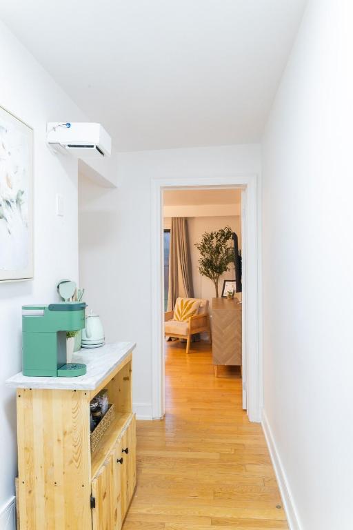 a white room with a kitchen with a table at Private 2-BR Suite w Patio in Mississauga