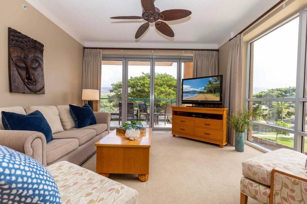 a living room with a couch and a tv at Honua Kai 322 · HK 322 Luxurious Kaanapali BeachFront 2BD Pool A in Lahaina