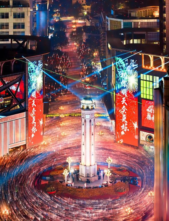 a night view of a city with a clock tower at KK Fashion Hotel Chongqing Jiefangbei Pedestrian Street Branch in Chongqing