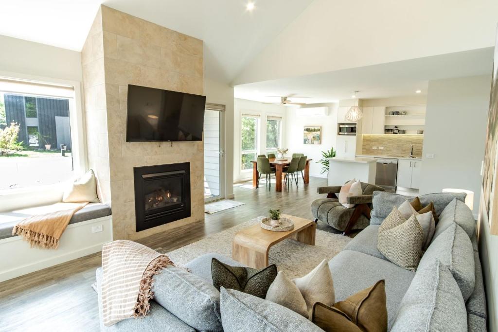 a living room with a couch and a fireplace at Amber Mist Villa - Two in Bright