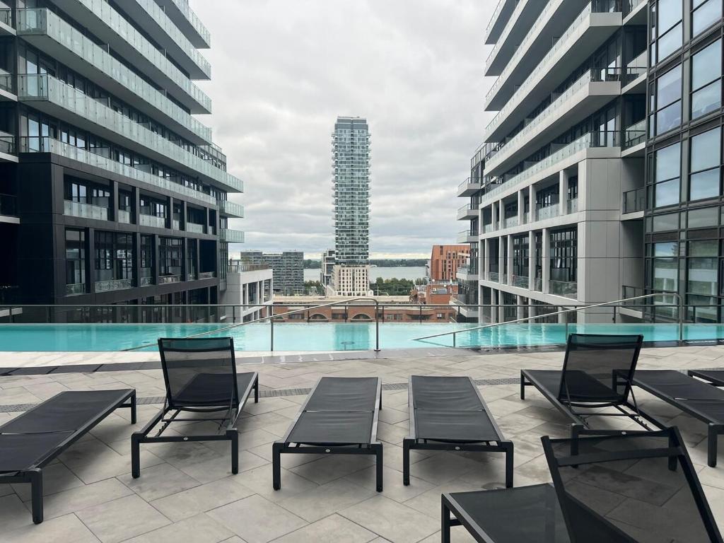 a group of chairs sitting on top of a building at Downtown Luxury Condo Gym & Parking in Toronto