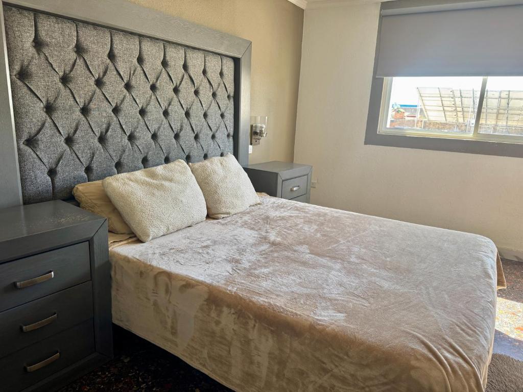 Postel nebo postele na pokoji v ubytování SUITE 4, Centro de Cuauhtemoc Chihuahua