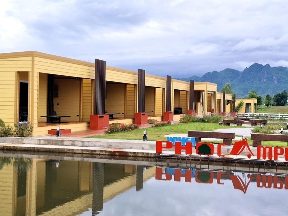 a row of buildings next to a body of water at ห่มฟ้าโพธิ์แค้มป์ปิ้ง 
