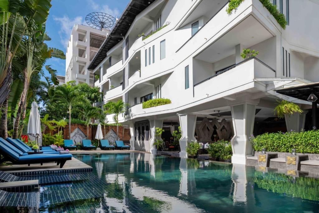 an exterior view of a hotel with a swimming pool at Central Suite Residence in Siem Reap