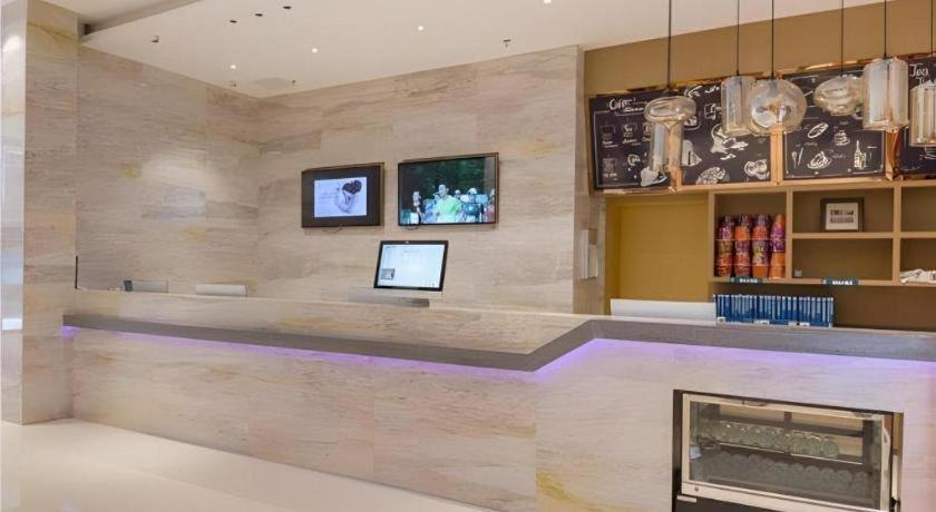 a lobby with a fireplace in a building at City Comfort Inn Liuzhou High-speed Railway Station Entrance in Liuzhou