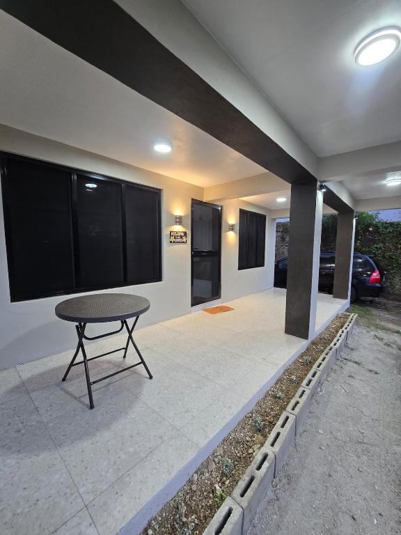 a patio with a table in front of a house at Raiwai homestay in Suva