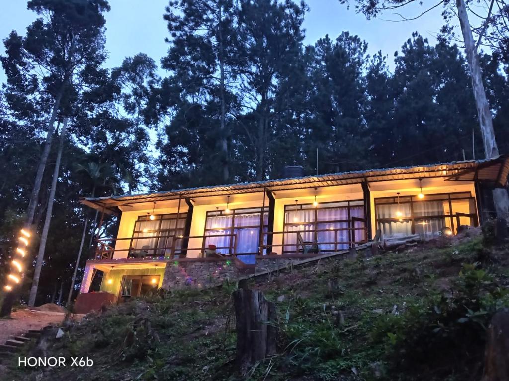 a house on top of a hill at night at Ravan Pine Nature Retreat in Ella